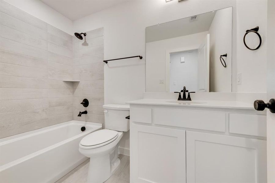 Bathroom featuring tub / shower combination and vanity Bathroom featuring tub / shower combination and vanity