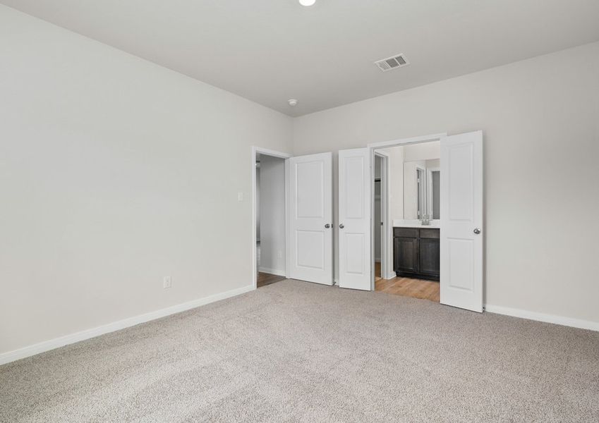 The master suite has a large bedroom, ensuite bathroom and a walk-in closet.