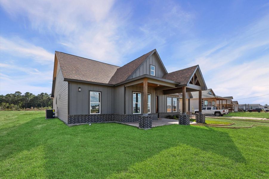 Charming single-story modern farmhouse on a large lot, highlighted by clean lines, gable accents, and inviting front porch—no back or left-side neighbors for exceptional privacy. Charming single-story modern farmhouse on a large lot, highlighted by clean lines, gable accents, and inviting front porch—no back or left-side neighbors for exceptional privacy.
