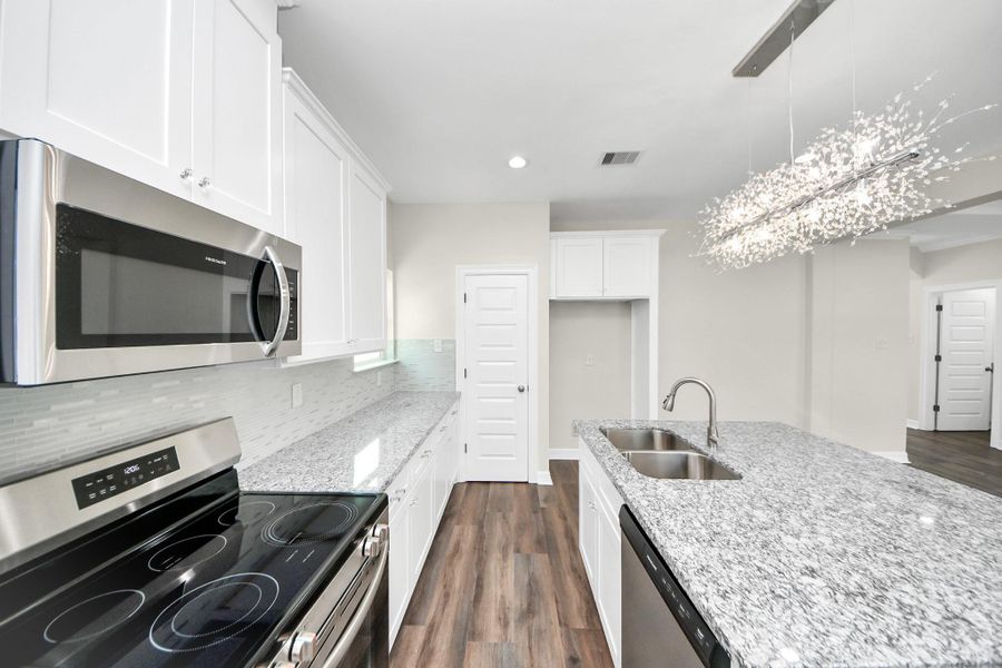 This beautifully designed kitchen offers an abundance of counter and cabinet space, providing plenty of storage to keep everything organized and within reach. The stylish flooring complements the cabinetry perfectly, creating a seamless and inviting look, while the spacious walk-in pantry ensures you’ll never run out of room for all your kitchen essentials - (representation photo).