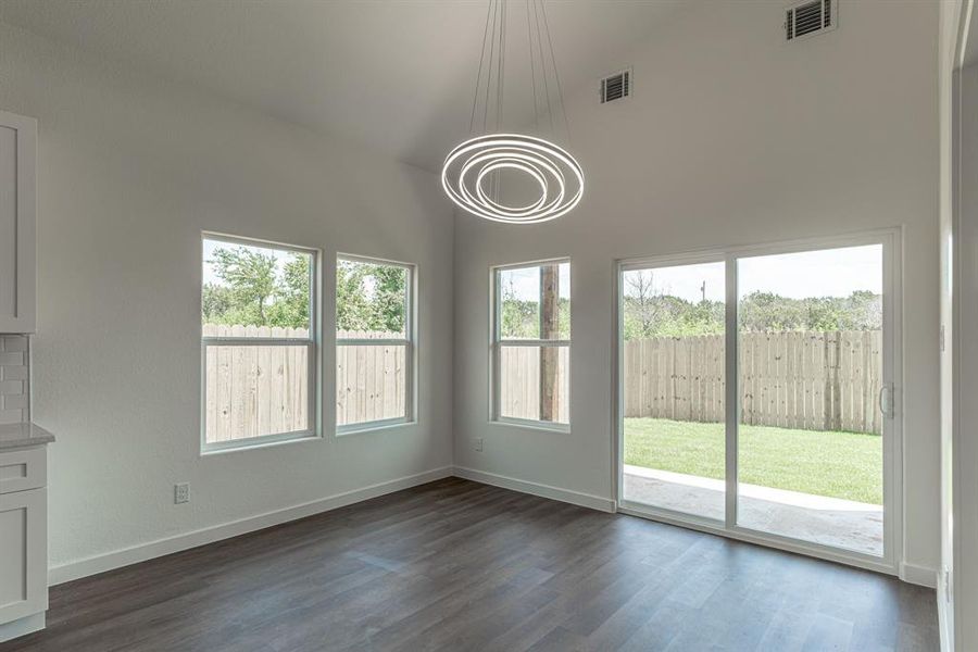 Dining area with lots of windows into back yard