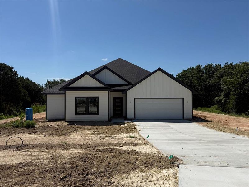 Front exterior of a new home in Freeman Ranch, Weatherford, TX, highlighting curb appeal (Image 1). Front exterior of a new home in Freeman Ranch, Weatherford, TX, highlighting curb appeal (Image 1).
