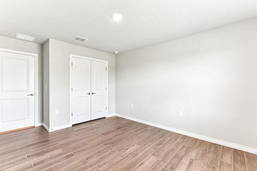Unfurnished bedroom featuring light wood-type flooring and a closet Unfurnished bedroom featuring light wood-type flooring and a closet