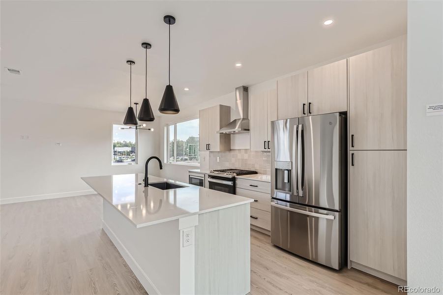 Open floorplan, great for relaxing or entertaining. Brightened by natural light from large windows. Kitchen includes all appliances and island seating.(NOTE: This home has a darker color scheme. See finishes for details.)