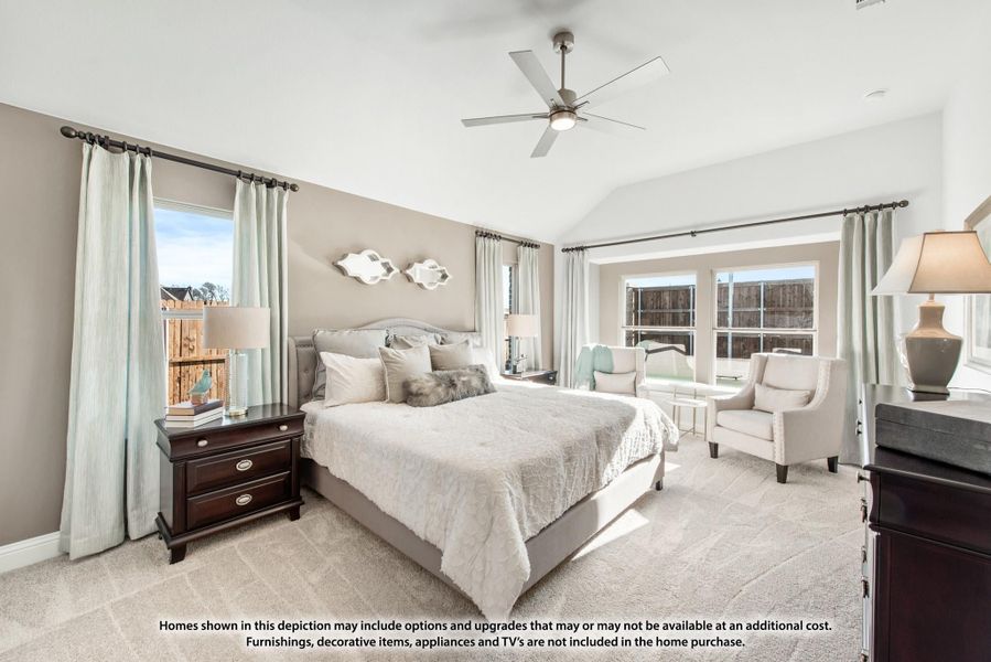 Spacious master bedroom with vaulted ceiling, ceiling fan, carpet flooring, and multiple windows Spacious master bedroom with vaulted ceiling, ceiling fan, carpet flooring, and multiple windows