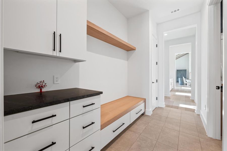 Mudroom featuring baseboards, visible vents, and light tile patterned floors Mudroom featuring baseboards, visible vents, and light tile patterned floors
