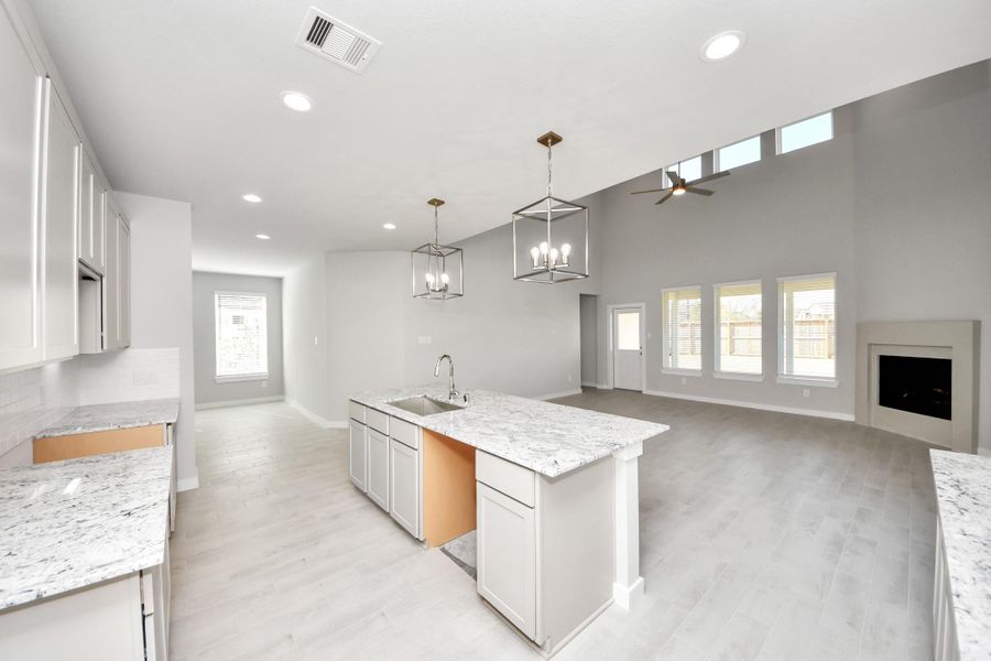 The open concept effortlessly connects the kitchen to the expansive family room, forming a perfect hub for gatherings. This seamless flow creates an inviting space where cooking and socializing come together harmoniously. Sample photo of completed home with similar floor plan. Actual colors and selections may vary.