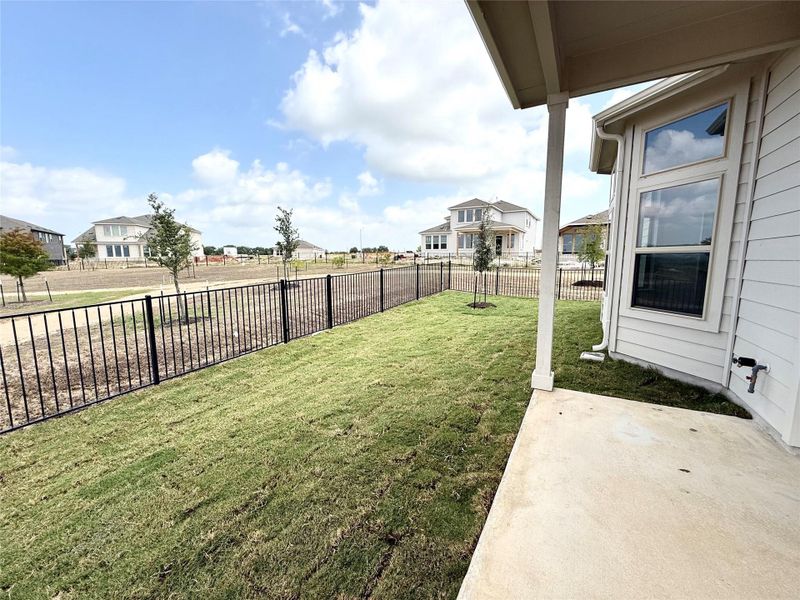 Fenced backyard with a patio and a residential view Fenced backyard with a patio and a residential view