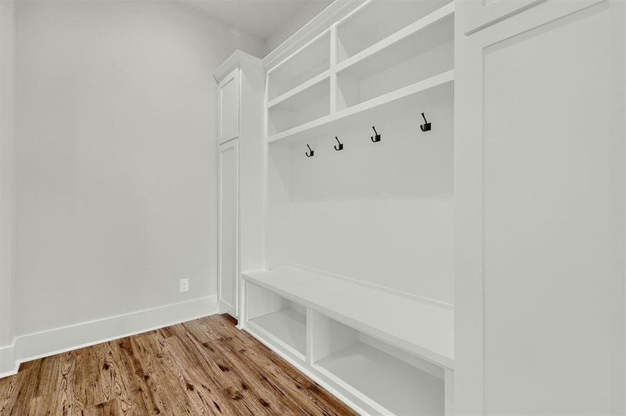 Mudroom with light hardwood / wood-style flooring