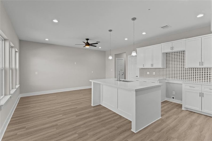 From the breakfast nook, take in the view of the large kitchen island and the connected living room—ideal for entertaining or relaxing.