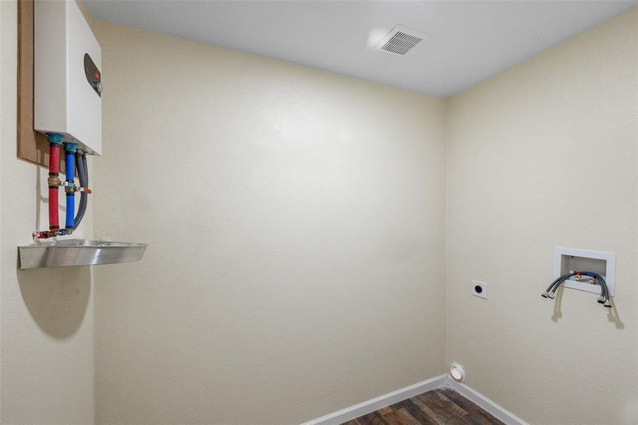 Washroom featuring electric dryer hookup, dark hardwood / wood-style flooring, and hookup for a washing machine