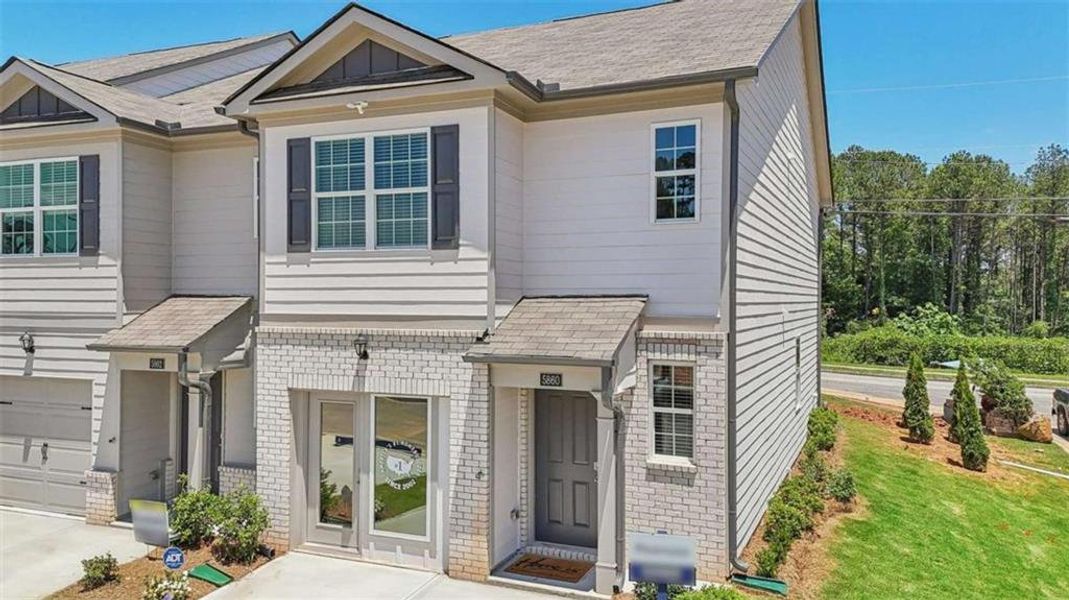 Front exterior of a new home in Wellington Park, Lithonia, GA, highlighting curb appeal (Image 22).