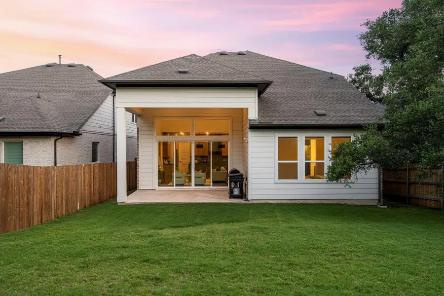 A spacious backyard with a patio provides an inviting outdoor living space.