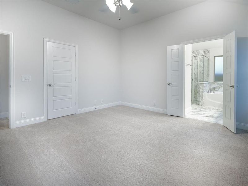 Carpeted empty room with ceiling fan