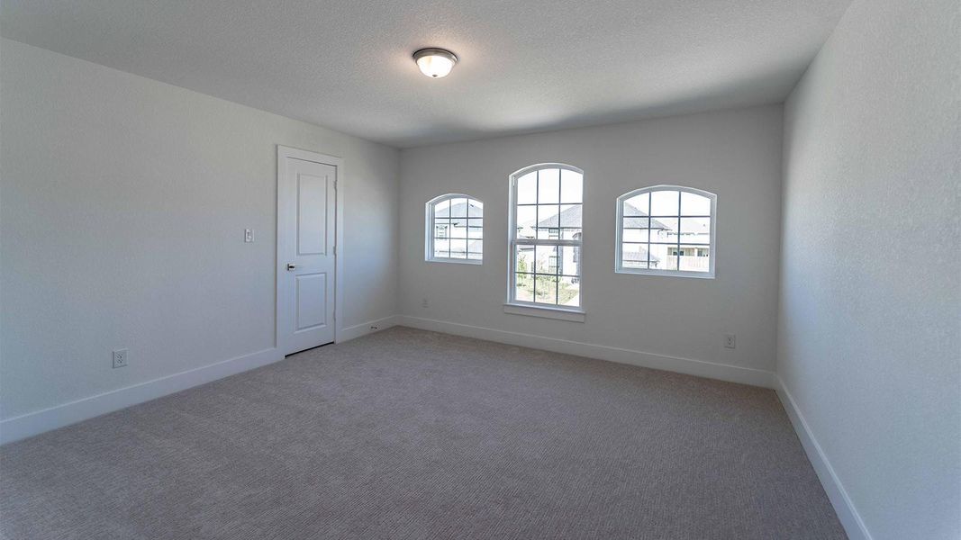 Carpeted empty room featuring baseboards and a textured ceiling Carpeted empty room featuring baseboards and a textured ceiling