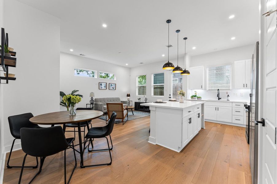 This inviting home features a spacious open-concept layout on the first floor, seamlessly connecting the living, dining, and kitchen areas to create a warm and functional gathering space. Large windows and glass door direct access to the backyard flooding the interior with natural light and extending the living space outdoors, perfect for entertaining or relaxing in the fresh air. The thoughtful design balances comfort and flow, making everyday living feel effortlessly connected to nature.