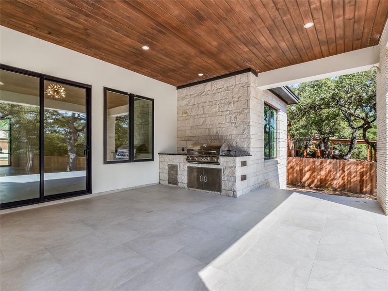 View of patio with exterior kitchen and area for grilling