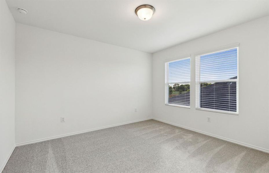 Secondary bedroom with ample closet space *real home pictured