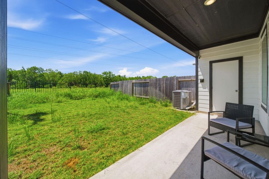 Spacious backyard featuring a covered patio, perfect for outdoor entertaining, relaxing, and enjoying the fresh air.