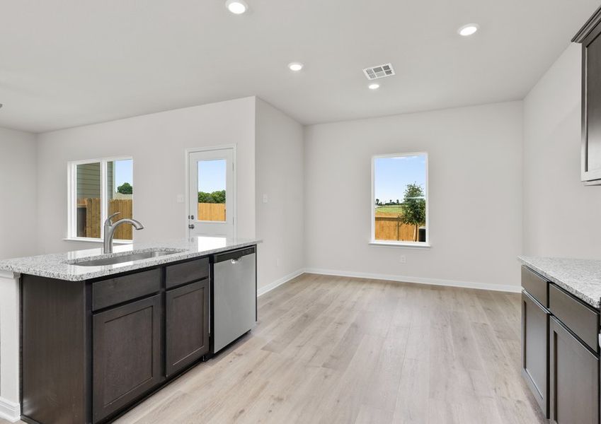 The dining room sits adjacent to the kitchen. The dining room sits adjacent to the kitchen.
