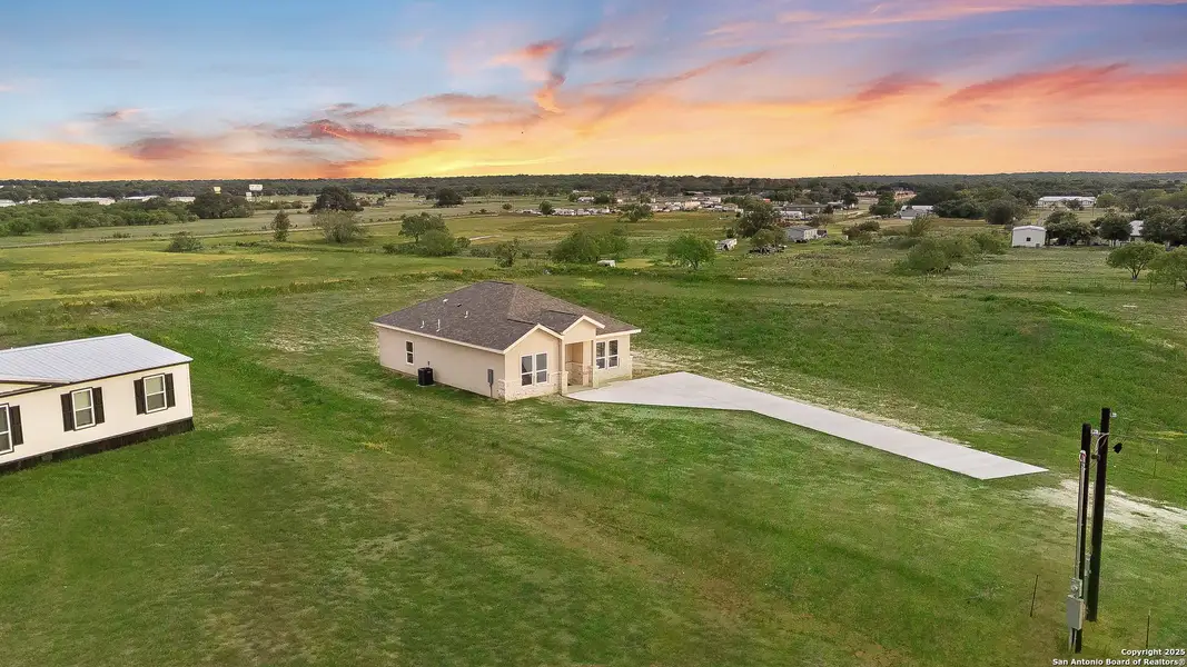 Front exterior of a new home in , La Vernia, TX, highlighting curb appeal (Image 2).