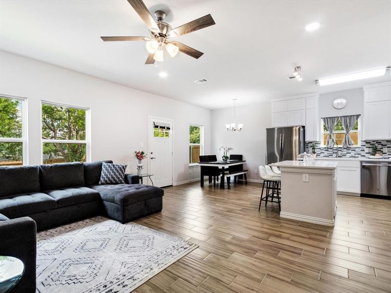 Open-concept living space featuring wood-finish flooring, recessed lighting, and a modern ceiling fan