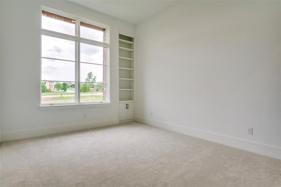 Unfurnished room featuring light colored carpet and baseboards