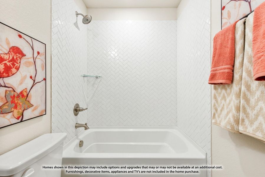 Bathtub and shower combo with white herringbone tile surround and brushed nickel fixtures Bathtub and shower combo with white herringbone tile surround and brushed nickel fixtures
