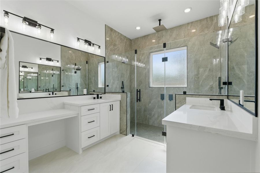 Your dream primary bath awaits — featuring dual sinks, a private vanity area, and a spacious glass-enclosed shower with five shower heads. Finally, room for everyone to get ready in peace!