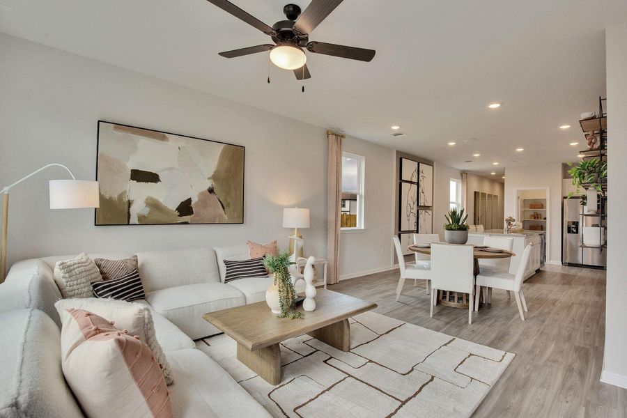 An open-concept layout unites the naturally illuminated living room, dining area, and kitchen, promoting seamless interaction. An open-concept layout unites the naturally illuminated living room, dining area, and kitchen, promoting seamless interaction.