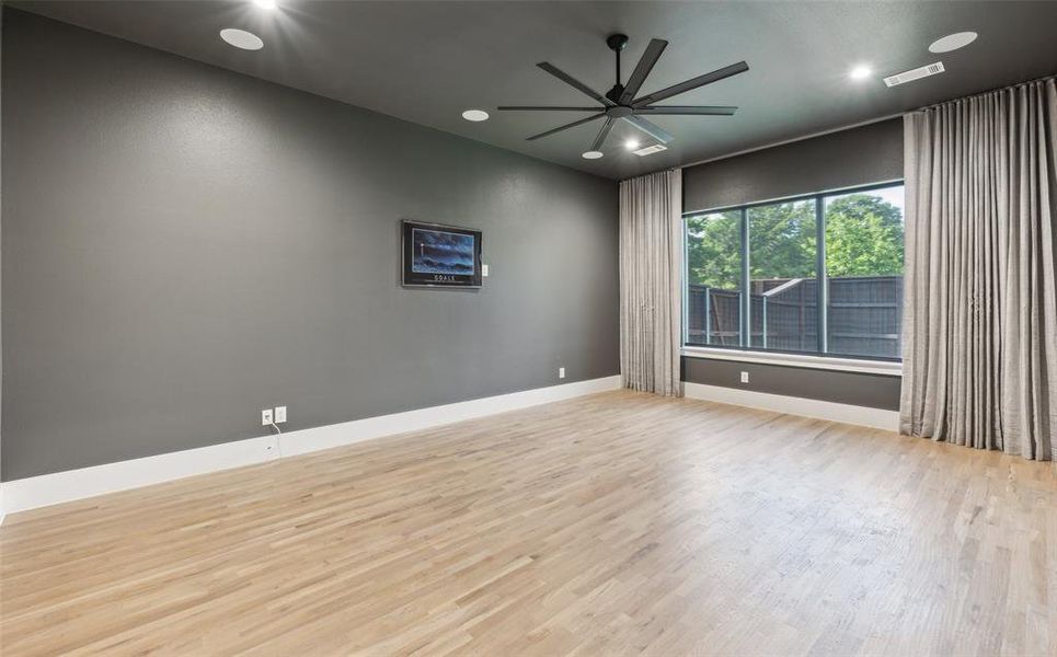 Spare room featuring ceiling fan and light hardwood / wood-style flooring