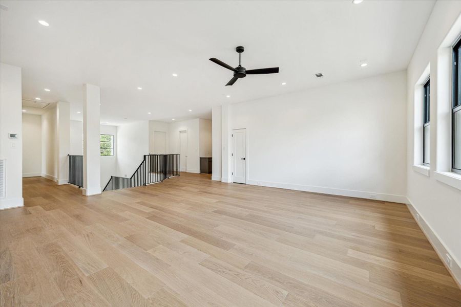 Spacious game room has European white oak flooring.