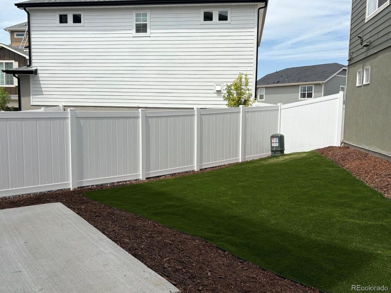 Front exterior of a new home in Green Valley Ranch, Aurora, CO, highlighting curb appeal (Image 25).