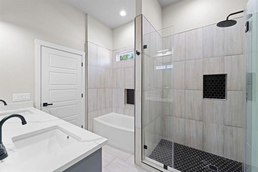 Bathroom featuring independent shower and bath, vanity, and tile patterned flooring