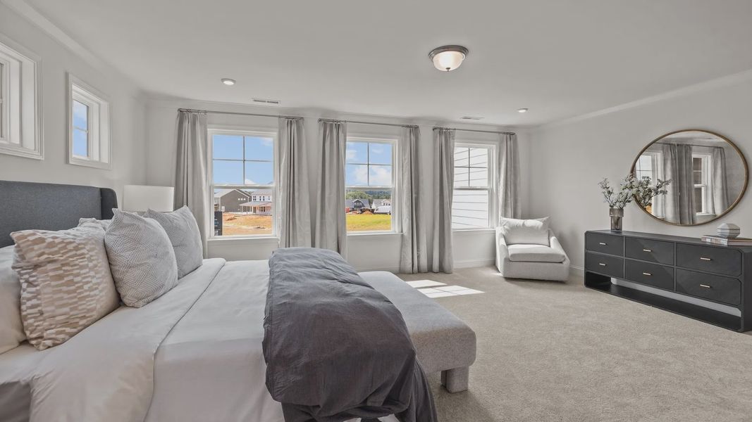 Luxurious primary bedroom retreat with plentiful windows in the Townsend Design by DRB Homes in Lakeside Glen, York, SC