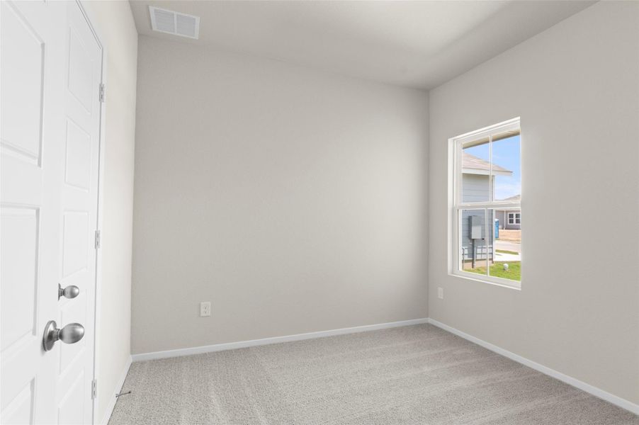 Spare room with light colored carpet and baseboards Spare room with light colored carpet and baseboards