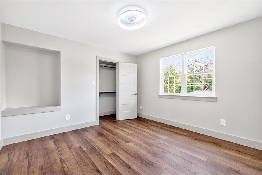 Unfurnished bedroom with light wood-style floors and a closet Unfurnished bedroom with light wood-style floors and a closet