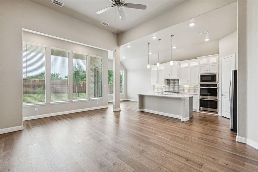 Unfurnished living room featuring a ceiling fan, wood finished floors, and recessed lighting