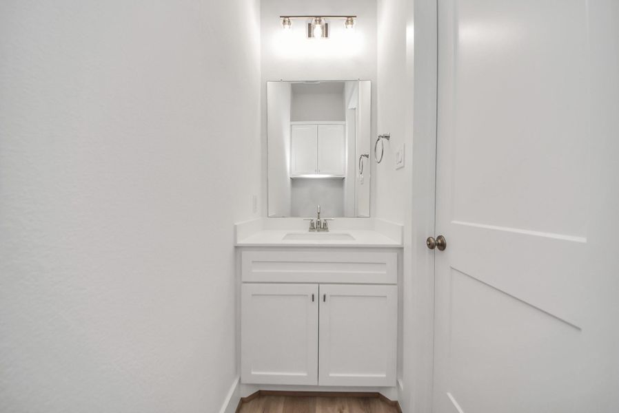 Stylish half bathroom with modern and clean finishes.