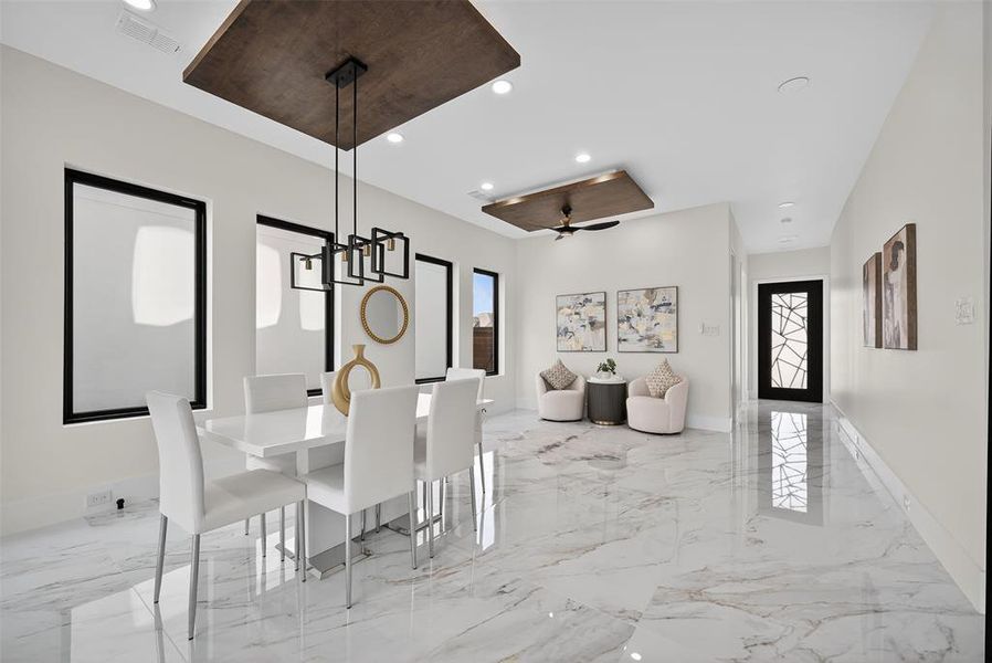Dining space with light marble finish flooring, a chandelier, recessed lighting, and a ceiling fan