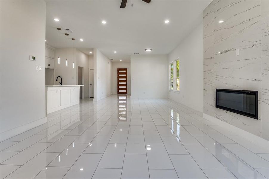 Unfurnished living room with recessed lighting, ceiling fan, and light tile patterned flooring
