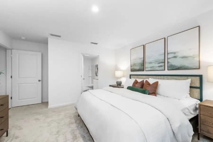 A bedroom with a bed and a couch.