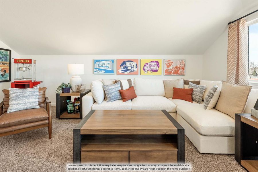 Bonus room with white sectional sofa, wood coffee table, and colorful drive-in movie wall art Bonus room with white sectional sofa, wood coffee table, and colorful drive-in movie wall art