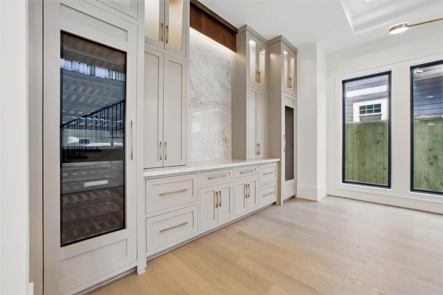 Sample of builder's previous construction. This home will have a similar dining room layout as pictured here. There will be a bar with built-ins and wine refrigeration and a ceiling treatment. Buyer still has time to select finishes. High-end appliance package will be used.