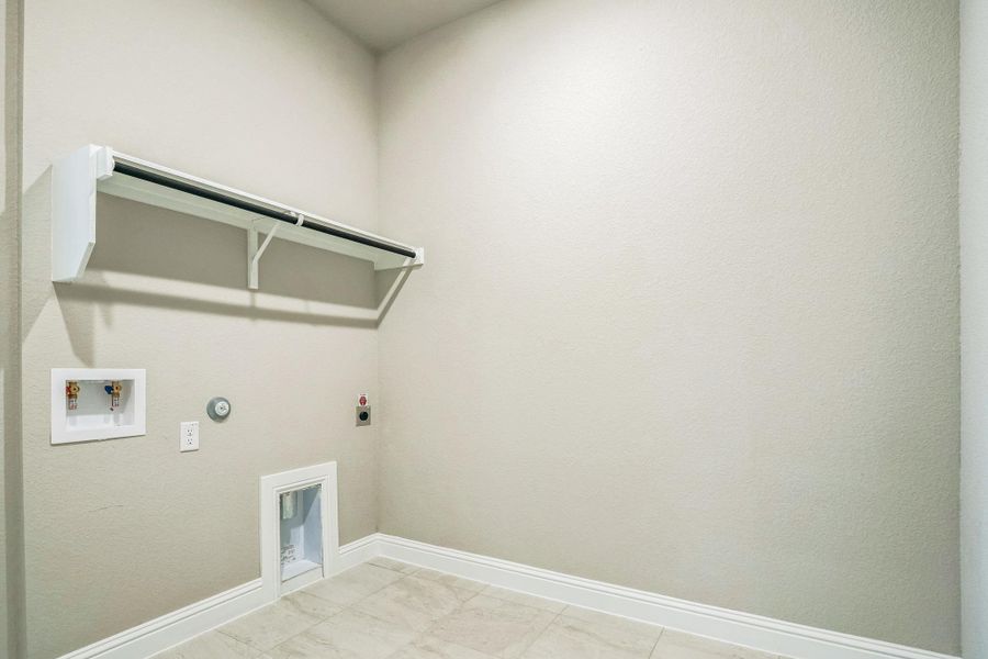 Laundry room featuring laundry area, gas dryer hookup, hookup for a washing machine, baseboards, and electric dryer hookup Laundry room featuring laundry area, gas dryer hookup, hookup for a washing machine, baseboards, and electric dryer hookup