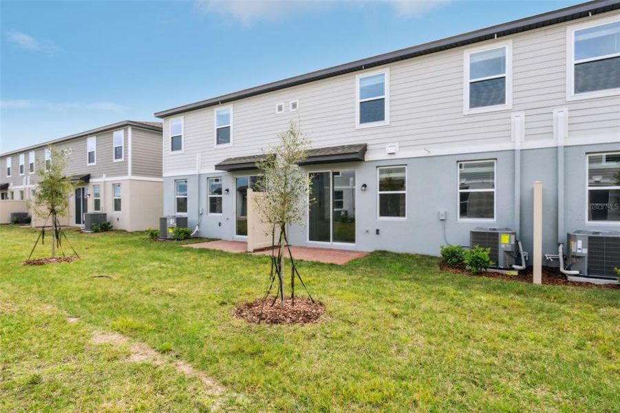 Exterior details and patio area of a home in The Meadow at Crossprairie Townes, St. Cloud (Image 23).