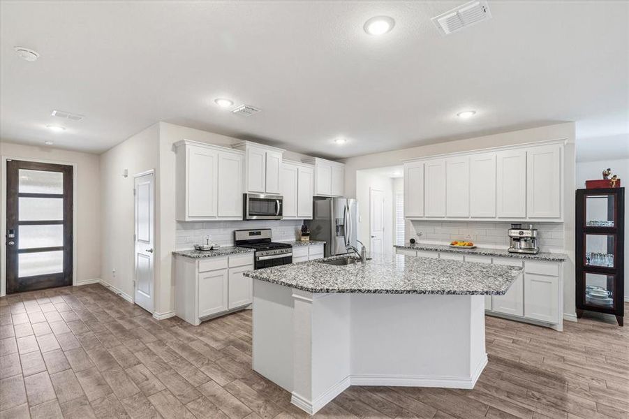 Another look at this lovely kitchen—don’t miss the spacious island, perfect for gathering and entertaining.