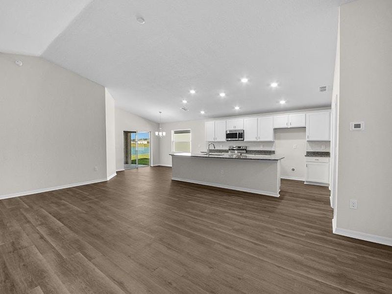 Inside, you`ll find a spacious, open living area with luxury vinyl plank flooring, under an airy volume ceiling.