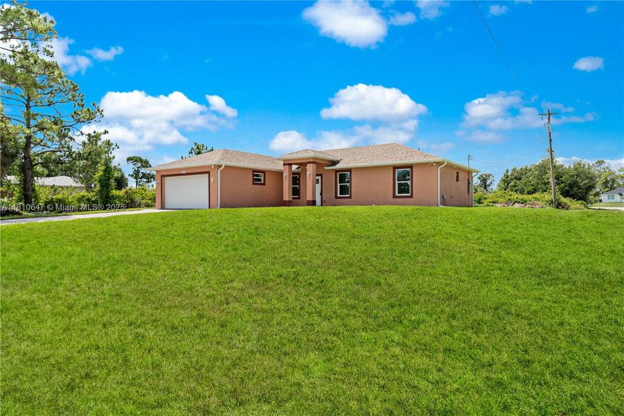Front exterior of a new home in , Lehigh Acres, FL, highlighting curb appeal (Image 14).
