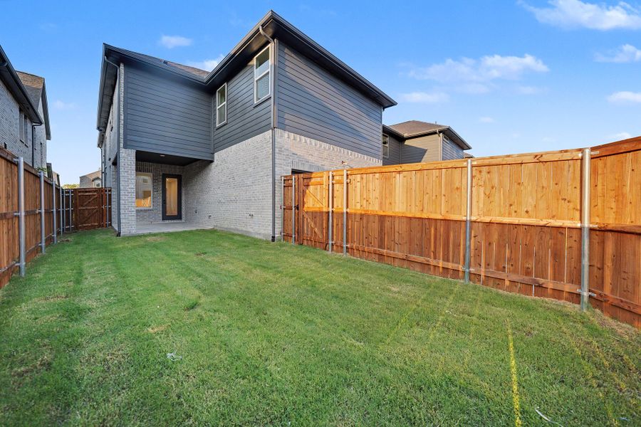 Exterior details and patio area of a home in Light Farms Brenham - 40' Lots, Celina (Image 4).